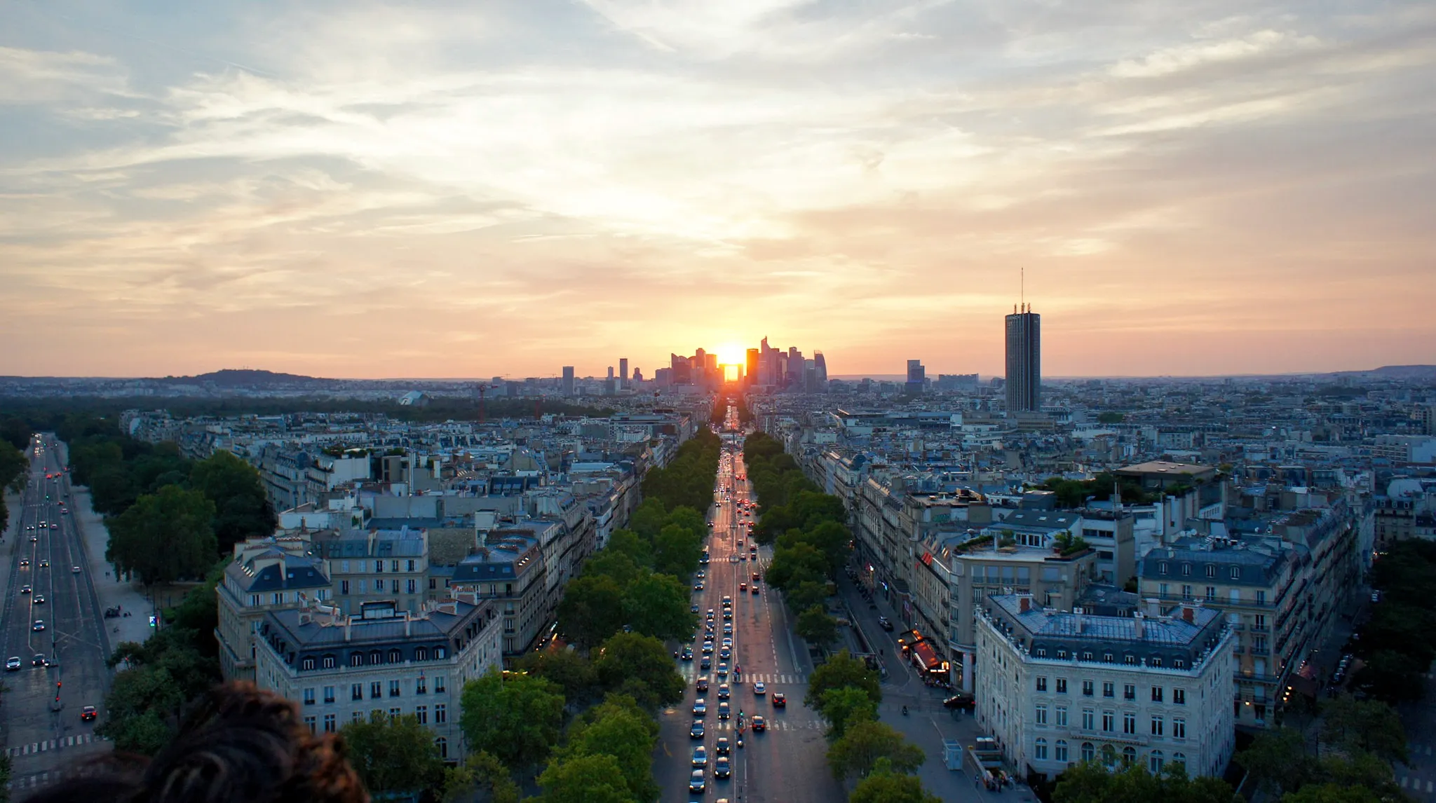 Voyages depuis Paris-Orly - Vue aérienne de Paris au coucher du soleil avec La Défense à l’horizon
